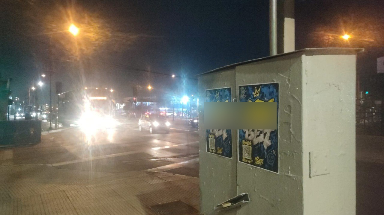 Completed large-format branded mural on a building wall in a high-traffic area of Santiago